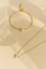 Load image into Gallery viewer, Floral Zircon Gold Bracelet by MJ Luxe displayed alongside a matching necklace on a beige background. This dainty gold bracelet features sparkling zircon stones in delicate floral motifs, creating an elegant minimalist design. Lightweight, versatile, and adjustable, it is perfect for everyday wear, stacking with other bangles, or gifting. A timeless piece of gold jewellery ideal for women, bridesmaids, birthdays, or anniversaries.