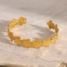 Load image into Gallery viewer, 18K gold flower cuff bracelet with engraved petals—waterproof, adjustable floral bangle on neutral stone background.