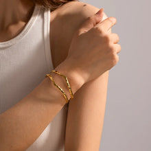 Load image into Gallery viewer, Stylish hammered double cuff bracelet in 18K gold plated stainless steel, shown on wrist with casual outfit. The textured hammered design catches light for a luxe finish. Adjustable open cuff fits most wrist sizes comfortably. A versatile piece that transitions from day to night, stacking easily with other bangles or worn solo. Perfect for gifting on birthdays, anniversaries, or as bridesmaid jewellery.