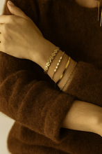 Load image into Gallery viewer, Model wearing MJ Luxe hammered gold coin cuff bracelet stacked with bangles, elegant textured design, minimalist jewellery styling inspiration.