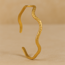 Load image into Gallery viewer, Hammered Gold Wave Cuff Bracelet by MJ Luxe, open adjustable sculptural bangle with wavy silhouette, minimalist jewelry design.