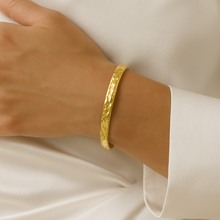 Load image into Gallery viewer, Close-up of Aurora Hammered Gold Cuff Bracelet on wrist, showcasing textured hammered finish and minimalist design, waterproof and tarnish-resistant adjustable gold bangle for women.