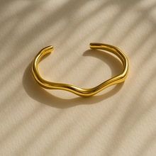 Load image into Gallery viewer, Minimalist Chloe Gold Wave Cuff Bracelet side view, sculptural open bangle with polished gold finish.
