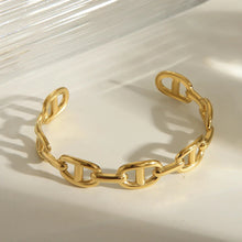 Load image into Gallery viewer, Gold Chain-link Cuff Bracelet by MJ Luxe Co displayed on a neutral background. This polished gold open cuff features interlocking chain-style links in a modern, minimalist design. Lightweight and adjustable to fit most wrists, it’s a versatile bracelet perfect for layering with other bangles or wearing solo as a statement accessory. Ideal as an everyday gold bracelet, a bridesmaid gift, or a timeless jewelry piece for women.
