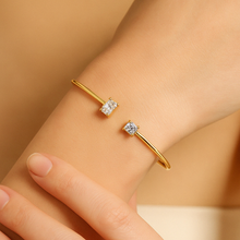 Load image into Gallery viewer, Close-up of the Gold Duo Diamond Cuff Bracelet on wrist, showing square-cut and rectangular diamond-inspired zircon stones set on a polished gold cuff. Minimalist women’s jewellery by MJ Luxe, timeless and stackable for modern elegance.
