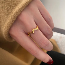 Load image into Gallery viewer, Gold Wave Ring in 18K gold plating size 7 worn solo on model’s index finger, styled with soft knit jumper for an elegant minimalist everyday jewellery look.

