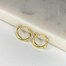 Load image into Gallery viewer, 18K gold plated sterling silver twist huggie hoop earrings against marble backdrop
